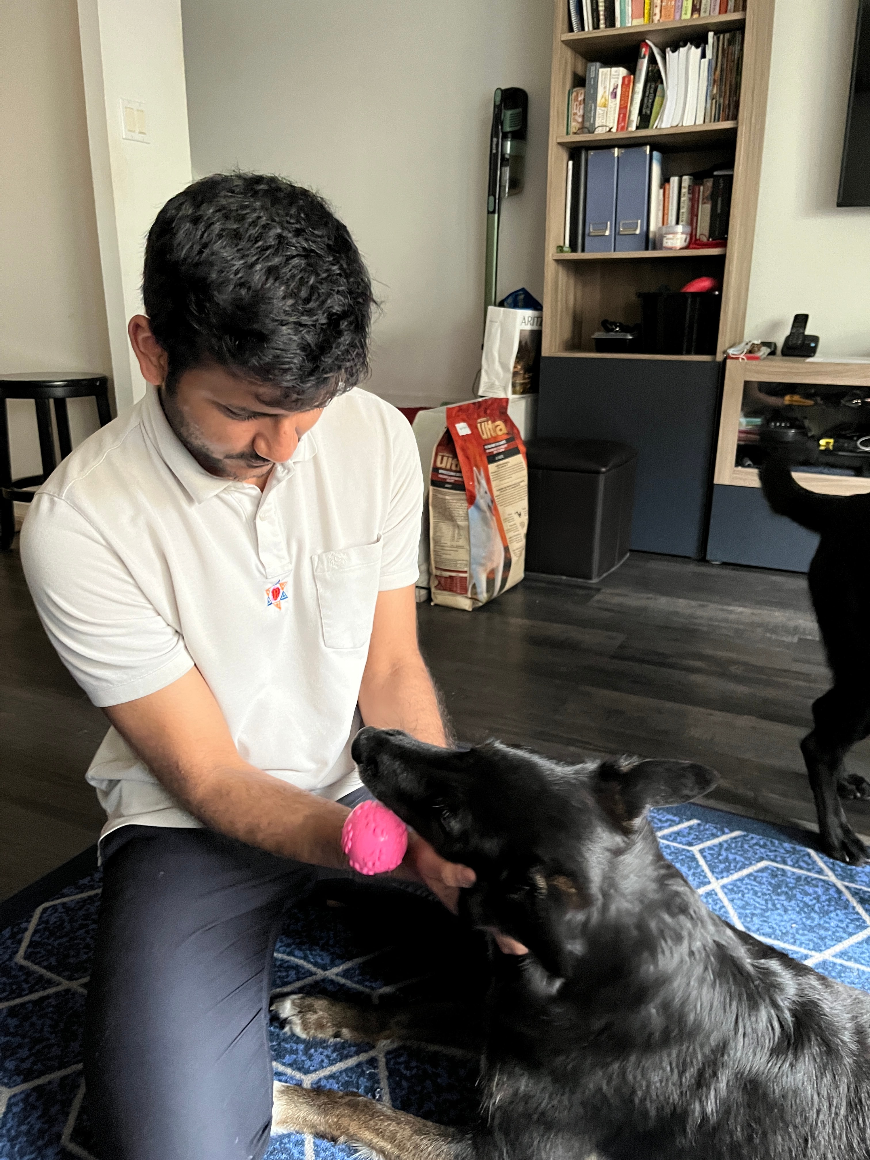 Atmiya playing with a dog at home
