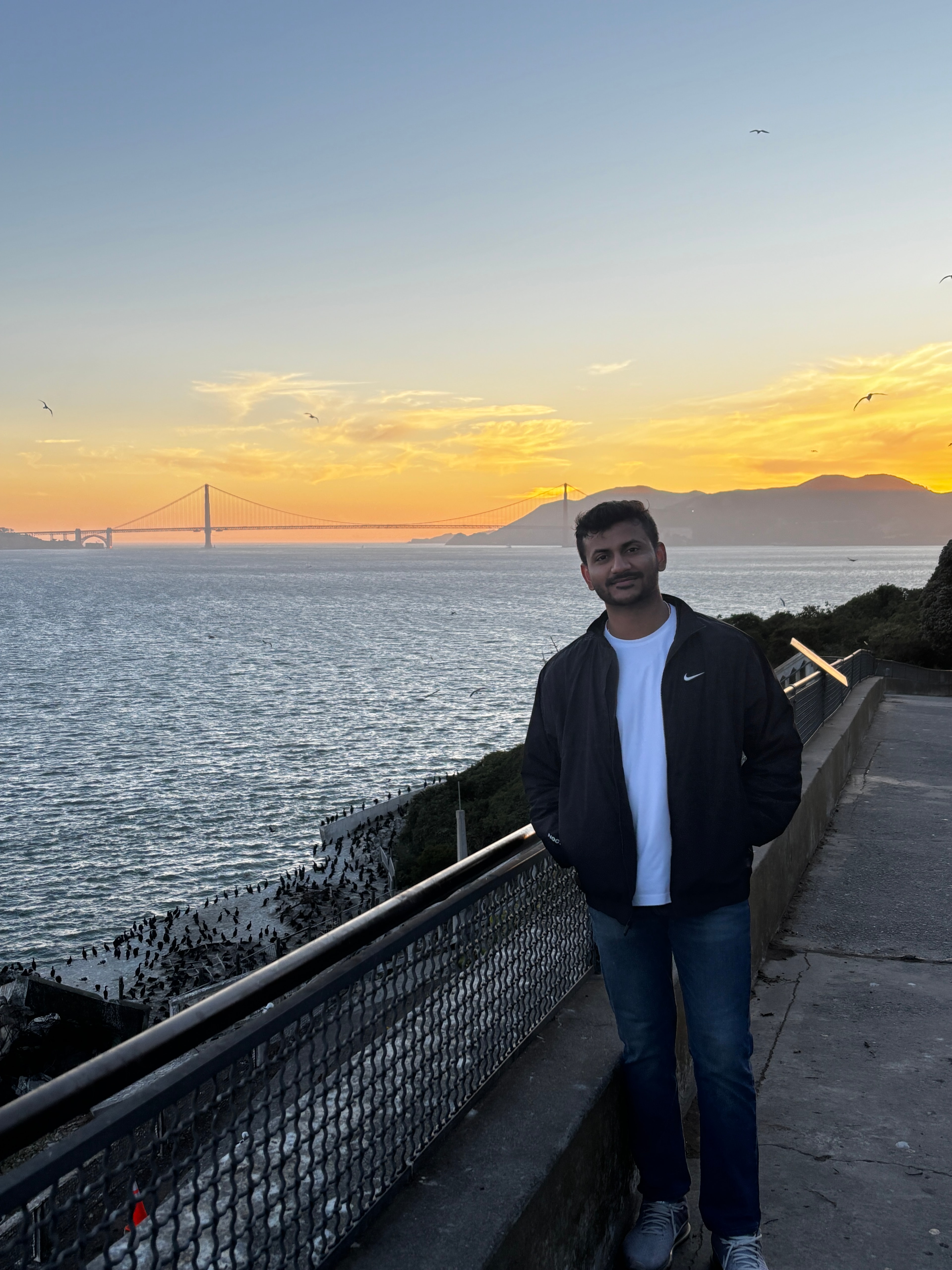 Atmiya at a San Francisco viewpoint overlooking the Golden Gate Bridge at sunset